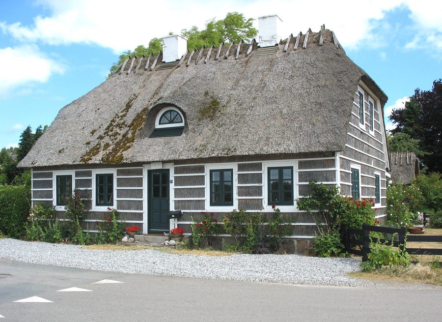 Charakteristisches historisches, mit Stroh verkleidetes Haus im Fischerdorf Hesnæs auf Falster