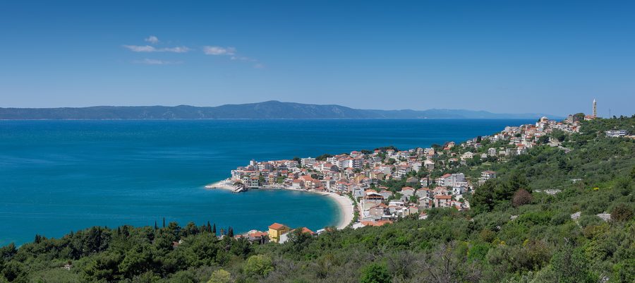 Panoramic view of Igrane, Croatia, with the coastal village, waterfront and surrounding mountains