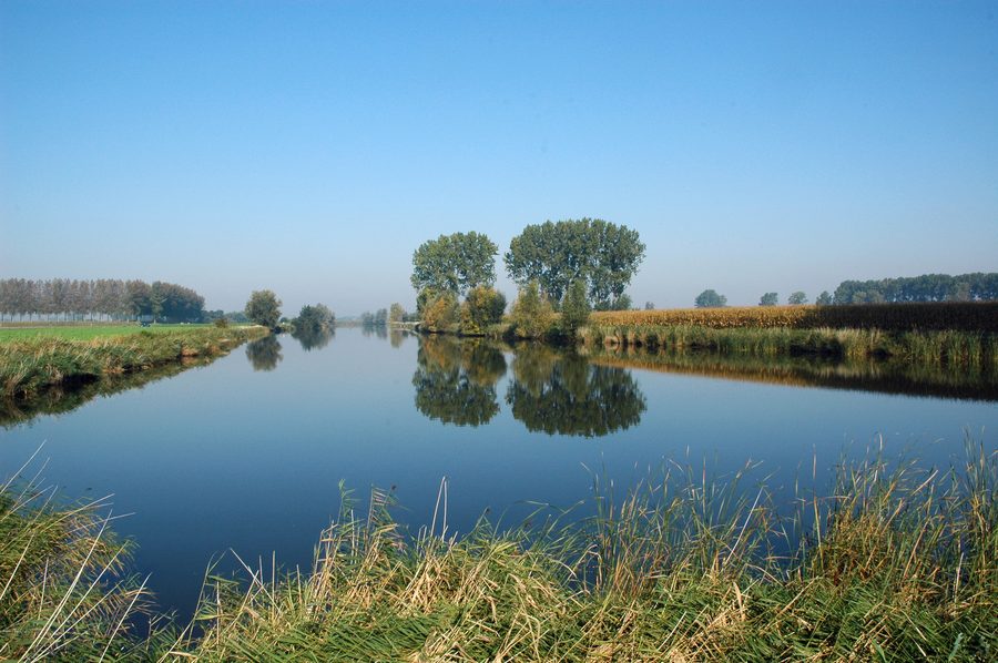 Blick auf die Hollandersgatkreek in Sint-Laureins mit flacher Polderlandschaft