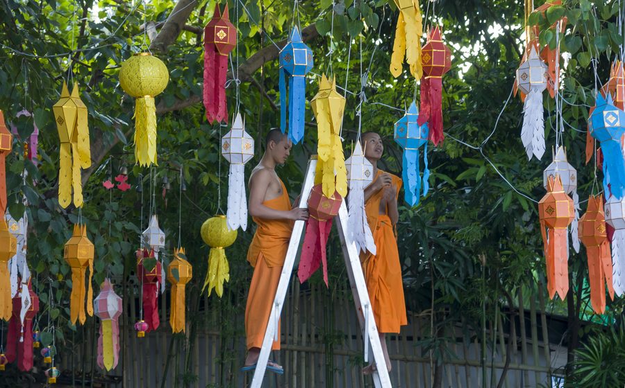Buddhist monks installing lanterns in Chiang Mai, Thailand. Buddhist monks installing lanterns in Chiang Mai, Thailand.