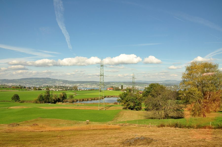 Itlimoosweiher bei Samstagern in Wollerau mit Landschaft im Hintergrund