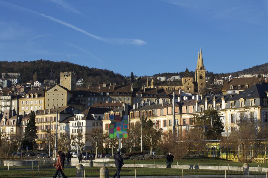 View over Neuchâtel with the lake and surrounding hills.